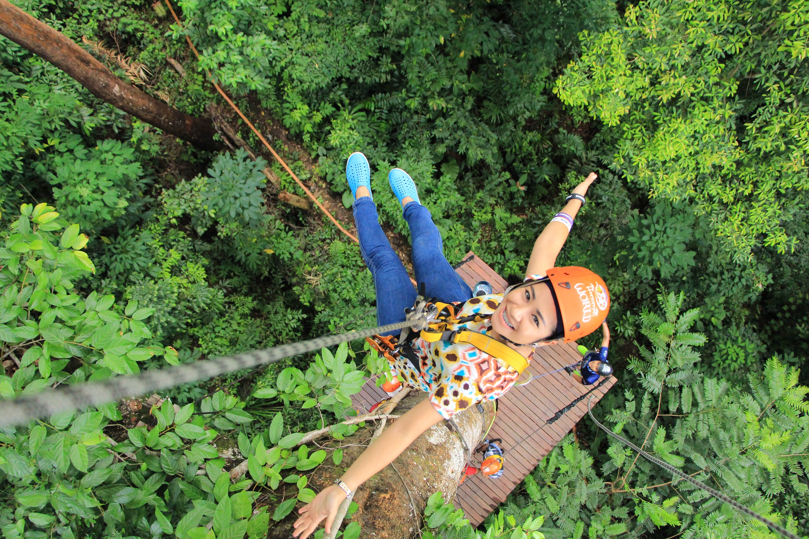 A woman is happy trying the zipline experience